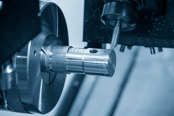 The  multi-tasking CNC lathe machine making the metal shaft parts by milling turret. The hi-technology metal working processing by CNC turning machine . © Pixel_B