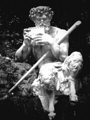 Skulptur Gottheit Pan sitzen am Fels mit Flöte und Stab schwarz