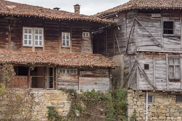 Fototapeta na wymiar Rural landscale, abandoned old typical traditional wooden houses. Architecture from Bulgarian National Revival period