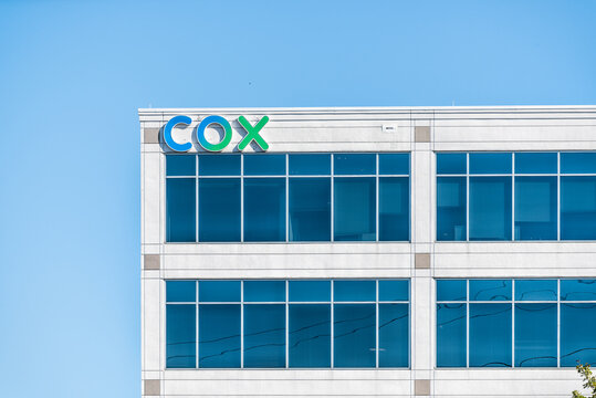 Herndon, USA - October 7, 2020: Cox Communications logo building sign in Northern Virginia for corporate business providing cable internet phone services