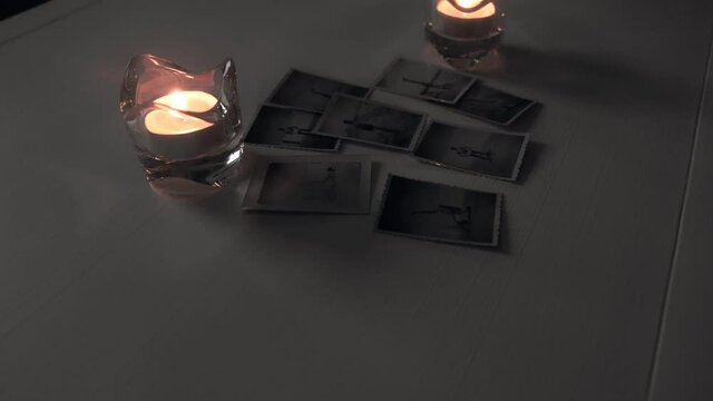 Candles with old photos, smooth movement of the camera approaching, movement with slider
