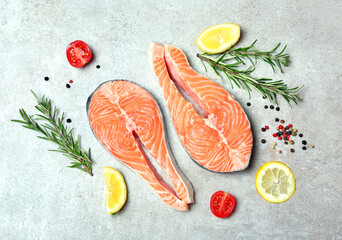 Salmon steaks served with lemon,rozmariry and papper.Healthy nutrition,seadood. Red fish sliced.