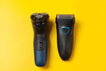 Foil and Rotary Electric Shavers on a yellow background