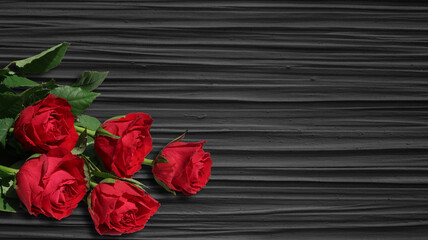 bouquet of fresh red roses on dark grey structured background - copy space