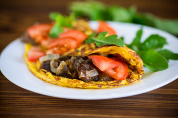 fried egg omelet with wild mushrooms and tomatoes