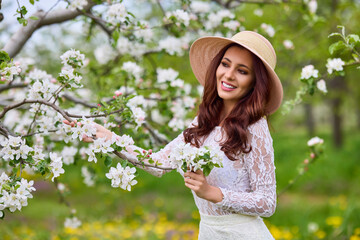 Beautiful natural woman in the garden of apple