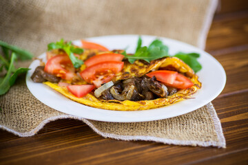 fried egg omelet with wild mushrooms and tomatoes