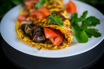 fried egg omelet with wild mushrooms and tomatoes