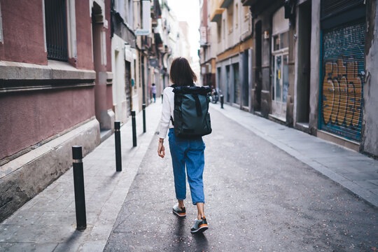 Woman tourist walking along street