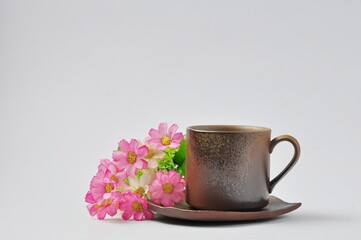  coffee mugs or tea mugs on bouquet fo flowers isolated form white background