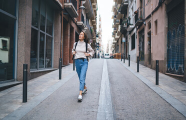 Cheerful woman walking on street