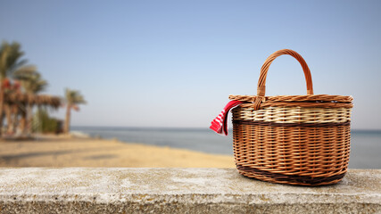 Picnic basket and summer time on beach 
