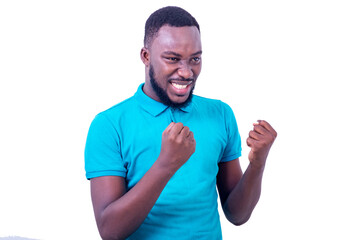 handsome young man making winning gesture while smiling.