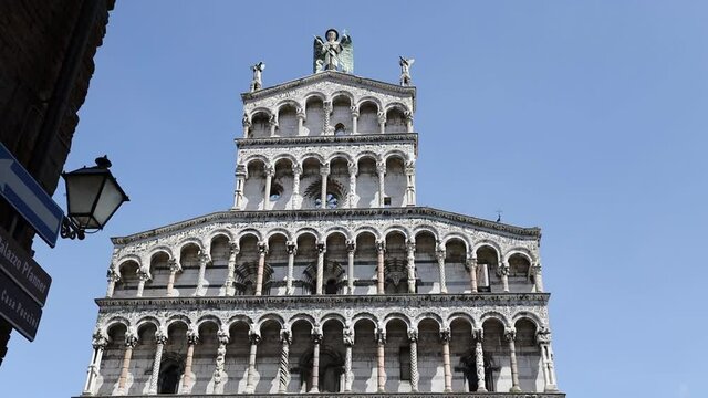 Walking through POV shot towards the San Michele in Foro Church in the medieval town of Lucca, Tuscany, Italy. Point of view. 