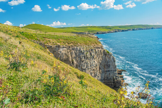 The swirling sea at the base of the Jurassic cliffs