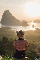 Young Woman in the morning sun of Phang Nga Bay in Sametnangshe viewpoint of Phang Nga province in Thailand.