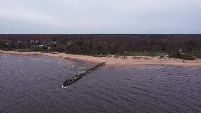 Aerial drone shot of breakwater at seaside jetty near Tuuja Beach, Latvia