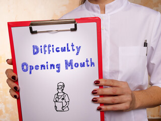 Medical concept meaning Difficulty Opening Mouth with sign on the piece of paper.