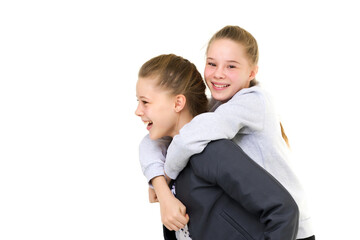 Happy Smiling Teen Girl Piggy Backing her Twin Sister