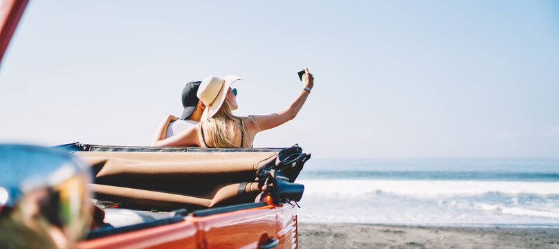 Couple using smartphone while taking selfie