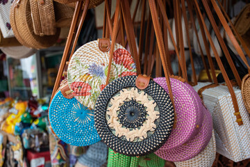 A bunch of stylish woman side hanging bag in a souvenir shop during the touristic visit in eastern asia