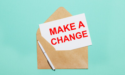 On a light blue background lies an open craft envelope, a white pen and a white sheet of paper with...