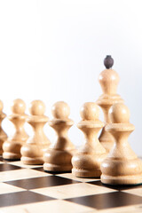 The king stands behind a row of white pawns. Chess composition