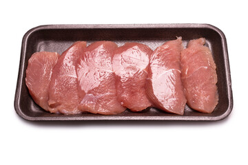 Turkey fillet in a black plastic container isolated.