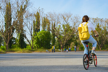 spring is comming concept with happy and cheerful feeling of asian woman riding bicycle