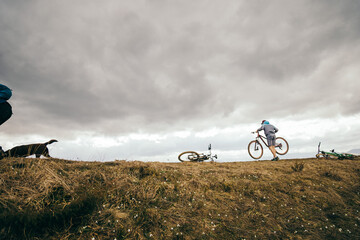 A person riding a bicycle on a dirt field