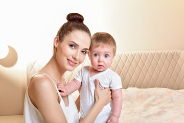 Mother and baby playing and smiling. Happy family.Home interior.