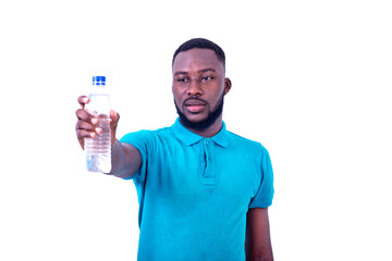 serious young man giving a bottle of mineral water.