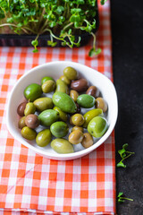 olive fruit fresh olives pitted in plate on the table veggie varieties vegan vegetarian food snack trend meal copy space food background rustic top view 