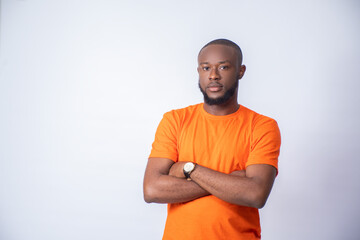 portrait of a young black man on a white background with hands crossed