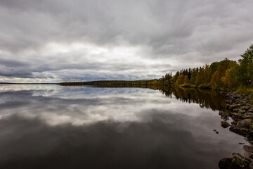 Dramatic autumn clouds reflection in Muonio lake, Lapland, Northern Finland