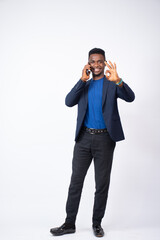 young black business man making a phone call does the okay gesture with his finger