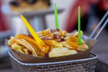 basket of crisps with bacon and colored plastic forks