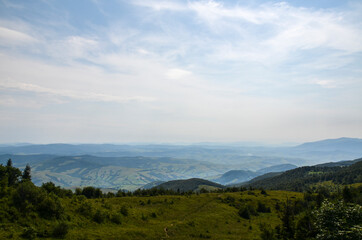 View from above of the hills mountains and fir trees home buildings in the village in summer season Carpathian mountains, Ukraine