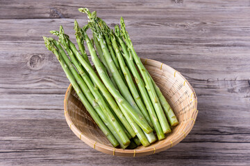 Fresh Asparagus. Bunch of fresh ripe green asparagus organic vegetables ready to cook. Group of Fresh asparagus on the wood background. Raw vegetable food for health cook