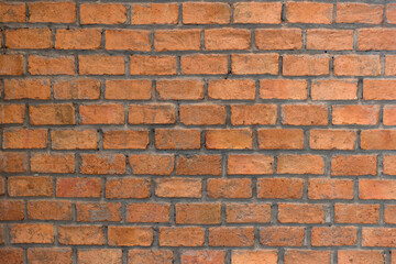 Red brick wall background in rural room. Abstract weathered texture stained old stucco light Red. Red grunge brick wall background. Misty brick wall for background or texture.