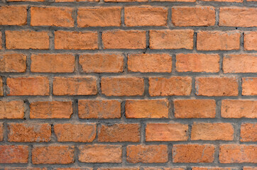 Red brick wall background in rural room. Abstract weathered texture stained old stucco light Red. Red grunge brick wall background. Misty brick wall for background or texture.