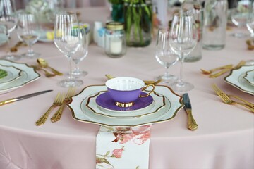 Close up of table set up for bridal shower, vintage tea set and floral napkins