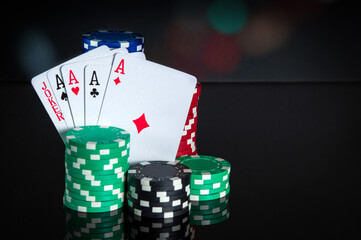 Poker cards with five of a kind combination. Close-up of playing cards and chips in poker club. Free advertising space