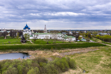 a panoramic view of the historical center of the temples and monasteries of the city of Suzdal in the rain filmed from a drone 
