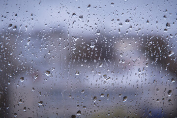 Rain drops on blue window close up