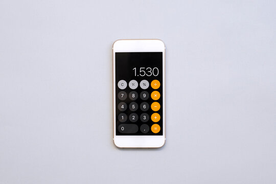 smart phone with calculator on gray background	