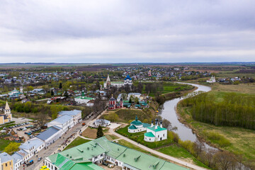 Fototapeta na wymiar a panoramic view of the historical center of the temples and monasteries of the city of Suzdal in the rain filmed from a drone 