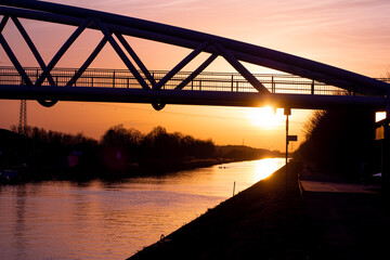 Pladdlers under the bridge at Datteln Hamm Kanal in the Ruhrgebiet at sunset