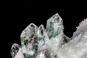 Chlorinated quartz crystals from the Himalayas. The larger, main crystals colored green and white are surrounded by hundreds of tiny, needle-like crystals. Shown with black background.
