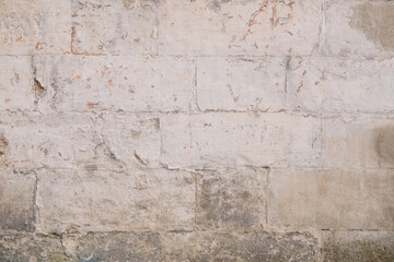 Old rough dirty painted light brick wall surface with cracks